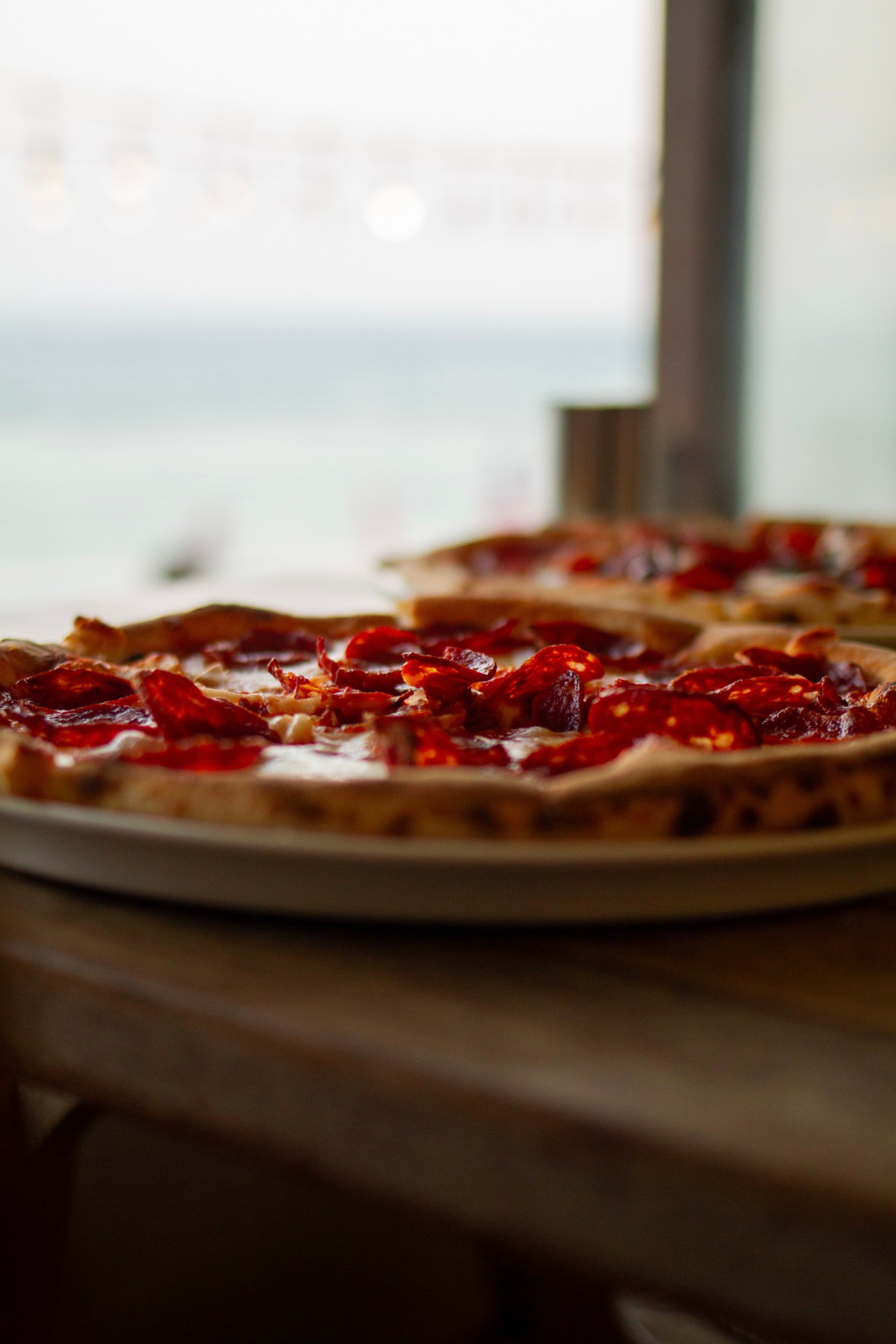 Spicy salami pizza served beside the sea at Veranda Lodge