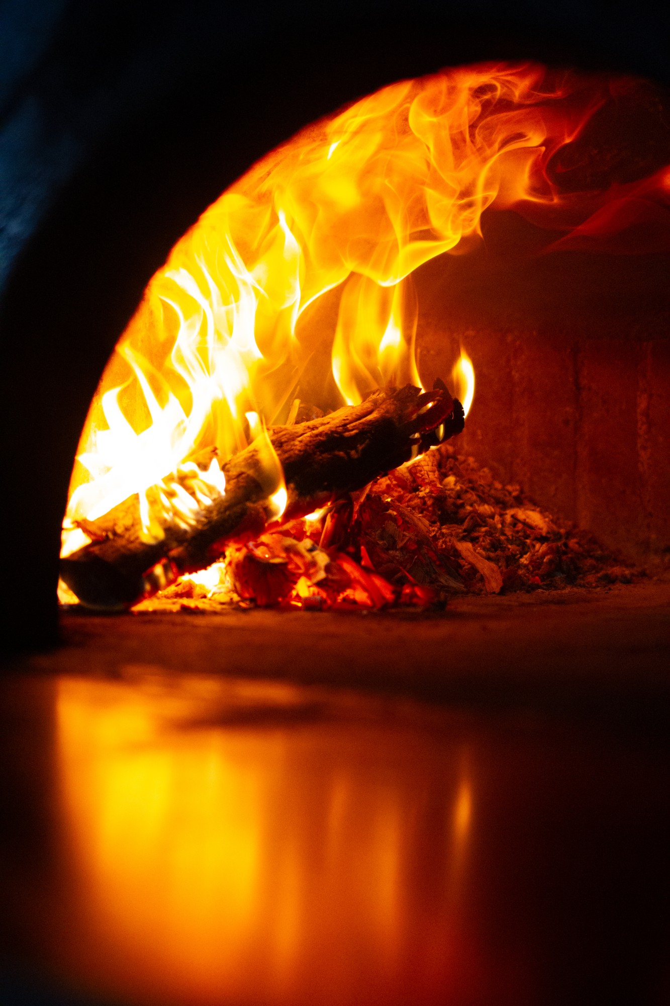 Logs burning inside the wood-fired oven