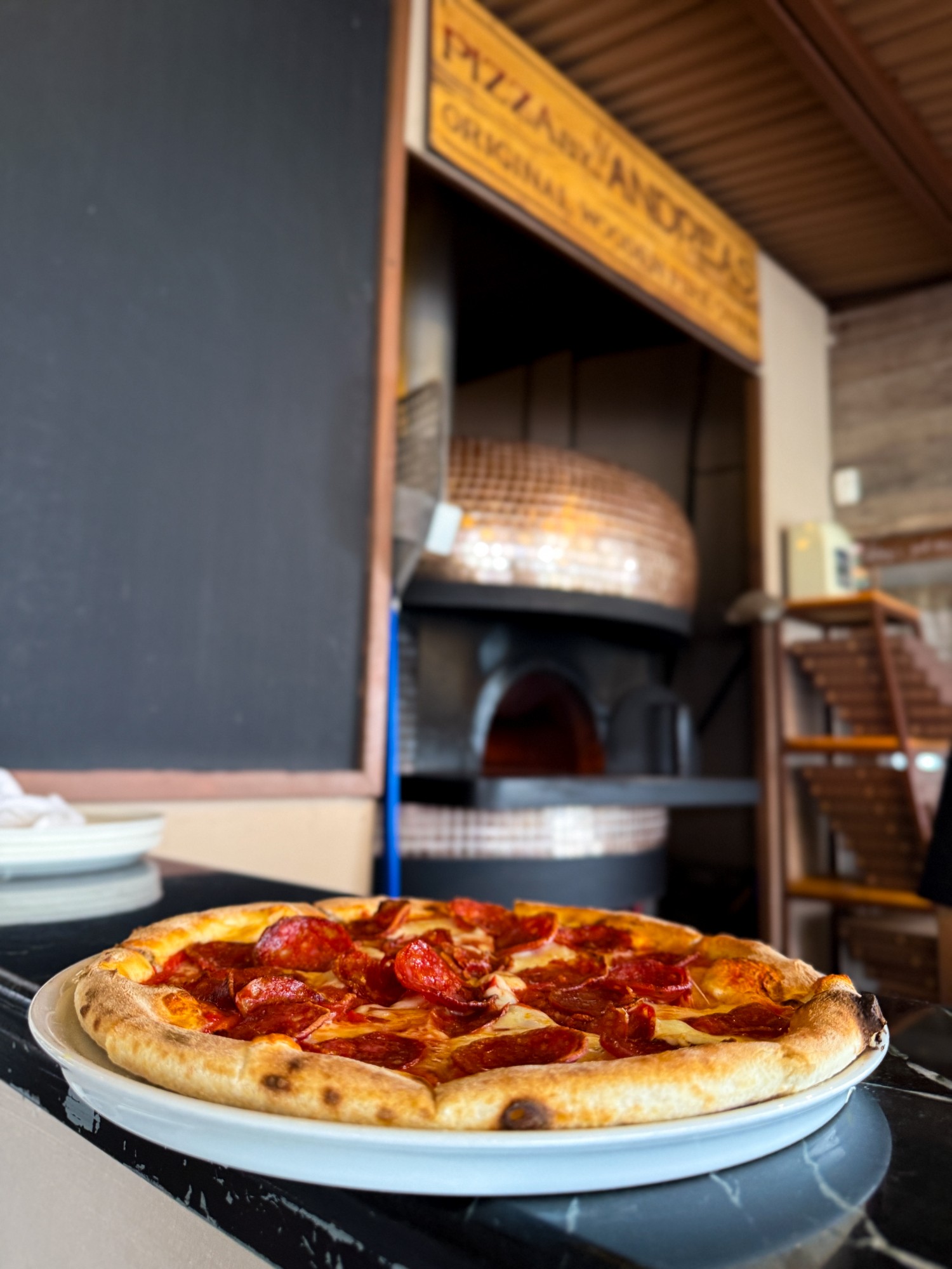 Pepperoni pizza plated at the oven station